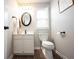 Updated bathroom with modern vanity, new fixtures, framed mirror, and wooden look flooring at 8970 Buttercup Ct, Noblesville, IN 46060