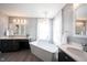Luxurious bathroom featuring a freestanding tub, double vanities, and elegant lighting fixtures at 8970 Buttercup Ct, Noblesville, IN 46060