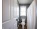 Bright bathroom with a white toilet, window, and shower featuring a clean, white shower curtain at 8970 Buttercup Ct, Noblesville, IN 46060