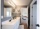 Stylish bathroom featuring a double sink vanity, modern fixtures, and a view into an adjacent room at 8970 Buttercup Ct, Noblesville, IN 46060