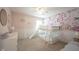Charming bedroom with floral wallpaper, a bunk bed with a slide, and soft, neutral carpeting at 8970 Buttercup Ct, Noblesville, IN 46060