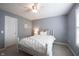 Bright bedroom featuring a white metal bed frame, neutral carpeting, and a window with natural light at 8970 Buttercup Ct, Noblesville, IN 46060