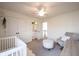 Bright Bedroom with white crib, chair, dresser, and closet access at 8970 Buttercup Ct, Noblesville, IN 46060