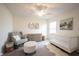 Cozy Bedroom featuring white crib, rocking chair, dresser, and stylish decor at 8970 Buttercup Ct, Noblesville, IN 46060
