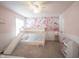 Bright bedroom featuring a bunk bed with a slide, floral wallpaper, and neutral carpeting at 8970 Buttercup Ct, Noblesville, IN 46060