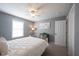 Well-lit bedroom featuring a white metal bed frame, artwork, and a small dark green cabinet at 8970 Buttercup Ct, Noblesville, IN 46060