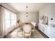 Elegant dining room with a wooden table, seating for eight, and natural light at 8970 Buttercup Ct, Noblesville, IN 46060
