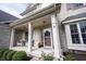 Close-up of front door with wreath and potted plants, welcoming guests to this well-maintained home at 8970 Buttercup Ct, Noblesville, IN 46060