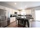 Bright eat-in kitchen with stainless steel appliances, granite countertops, and hardwood floors at 8970 Buttercup Ct, Noblesville, IN 46060