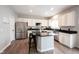 Modern kitchen with white cabinetry, granite countertops, stainless steel appliances, and a center island at 8970 Buttercup Ct, Noblesville, IN 46060