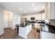 Kitchen with an island featuring stainless steel appliances, hardwood floors, and modern countertops at 8970 Buttercup Ct, Noblesville, IN 46060