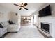 Open-concept living room featuring fireplace, tv, hardwood floors, and flows into kitchen at 8970 Buttercup Ct, Noblesville, IN 46060
