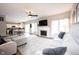 Spacious living room featuring a fireplace, large windows, and an open layout flowing into the kitchen at 8970 Buttercup Ct, Noblesville, IN 46060
