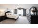 Spacious main bedroom featuring a vaulted ceiling, ceiling fan, dresser and ensuite bath at 8970 Buttercup Ct, Noblesville, IN 46060