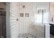 Modern tile shower featuring white subway tile, glass doors, and built-in niche at 8970 Buttercup Ct, Noblesville, IN 46060