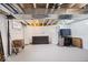 Spacious unfinished basement with painted floor, drop ceiling, and exposed ductwork at 925 S State Ave, Indianapolis, IN 46203