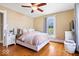 Charming bedroom featuring hardwood floors, a plush bed, and a large window for natural light at 925 S State Ave, Indianapolis, IN 46203