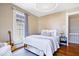 Inviting bedroom with hardwood floors, soft lighting, and a guitar as an accent piece at 925 S State Ave, Indianapolis, IN 46203