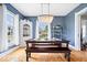 Stylish dining room with hardwood floors, blue walls, decorative chandelier, and bright windows at 925 S State Ave, Indianapolis, IN 46203