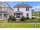 Charming two-story home with a well-manicured front yard and a black wrought iron fence at 925 S State Ave, Indianapolis, IN 46203
