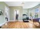 Bright flex room with hardwood floors, lots of light, exercise equipment, and adjacent bathroom at 925 S State Ave, Indianapolis, IN 46203