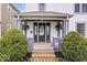 Inviting front porch with decorative plants, wreath, and flowers create a warm welcome at 925 S State Ave, Indianapolis, IN 46203