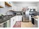 Bright kitchen featuring stainless steel appliances, white cabinets, and a red patterned rug at 925 S State Ave, Indianapolis, IN 46203