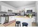 Well-lit kitchen with an island, stainless steel appliances, white cabinetry, and a patterned rug at 925 S State Ave, Indianapolis, IN 46203