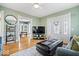 Stylish living room with hardwood floors, modern decor, and an open view to dining area at 925 S State Ave, Indianapolis, IN 46203