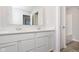 Bathroom featuring double sinks, white cabinetry, and a view into the shower at 9767 Behner Dr, Fishers, IN 46250