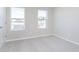 A brightly lit bedroom with carpet and two windows bringing in natural light at 9767 Behner Dr, Fishers, IN 46250