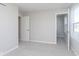Well lit bedroom with gray carpet, a closet, and doorway leading to another room at 9767 Behner Dr, Fishers, IN 46250