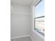 Walk-in closet featuring wire shelving for optimal organization and natural light from a window at 9767 Behner Dr, Fishers, IN 46250