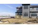 Modern home exterior featuring gray siding, a small deck, and multiple windows at 9767 Behner Dr, Fishers, IN 46250