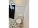 Modern bathroom featuring sleek black tile shower and decorative mosaic tile flooring at 100 Lincoln St, Plainfield, IN 46168