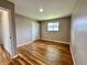 Neutral bedroom with hardwood floors, double closet, and a window providing natural light at 100 Lincoln St, Plainfield, IN 46168
