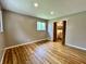 Neutral bedroom with hardwood floors, closet, and a window providing natural light at 100 Lincoln St, Plainfield, IN 46168