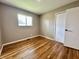 Cozy bedroom with hardwood floors, closet, and a window providing natural light at 100 Lincoln St, Plainfield, IN 46168
