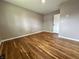 This bedroom features hardwood floors, a neutral wall color, and a white closet at 100 Lincoln St, Plainfield, IN 46168