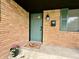 Charming front porch area with brick facade, stylish light fixture and a cozy welcome mat at 100 Lincoln St, Plainfield, IN 46168