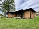 Charming brick home with green shutters, front porch seating, and landscaped yard at 100 Lincoln St, Plainfield, IN 46168