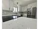 Close-up of a kitchen featuring quartz countertop, stainless steel appliances, and tiled backsplash at 100 Lincoln St, Plainfield, IN 46168