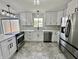 Updated kitchen with stainless steel appliances, white cabinets, and stylish countertops at 100 Lincoln St, Plainfield, IN 46168