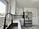 Bright kitchen with a stainless steel sink, modern faucet, and decorative backsplash at 100 Lincoln St, Plainfield, IN 46168