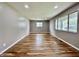 Bright living room with hardwood floors and large windows, offering plenty of natural light at 100 Lincoln St, Plainfield, IN 46168