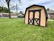 Backyard storage shed on a well-maintained lawn, ideal for storing outdoor equipment at 100 Lincoln St, Plainfield, IN 46168