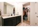 Bathroom featuring a double vanity with granite countertop and a walk-in closet at 10107 Camp Creek Way, Indianapolis, IN 46229