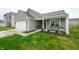 Inviting home with a cozy front porch featuring comfortable seating and green lawn at 10107 Camp Creek Way, Indianapolis, IN 46229