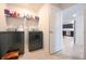 Well-equipped laundry room with modern washer and dryer and convenient shelving for storage at 10107 Camp Creek Way, Indianapolis, IN 46229