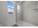 Bathroom features a tiled shower with a glass door and a window providing natural light at 10126 Redwood Peak Ln, Indianapolis, IN 46259